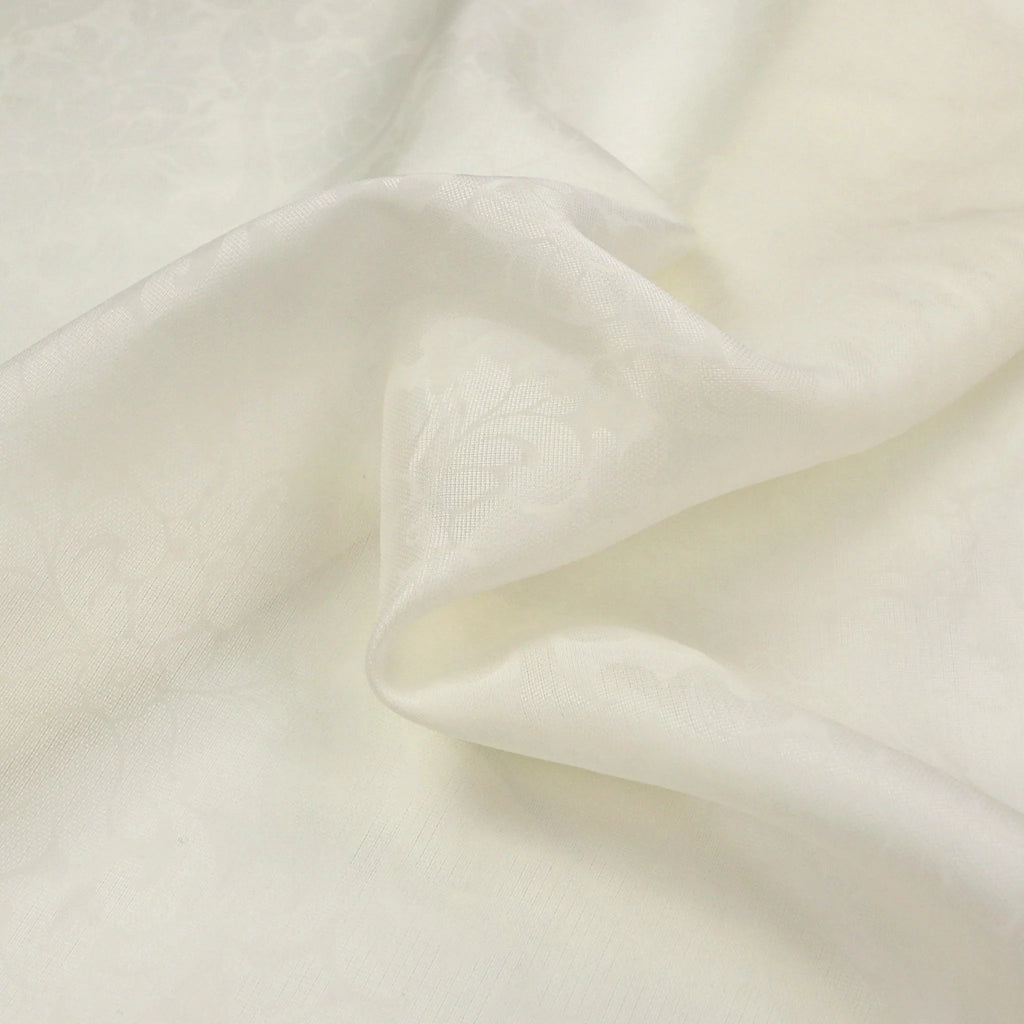 Close-up of ivory color fabric with folds