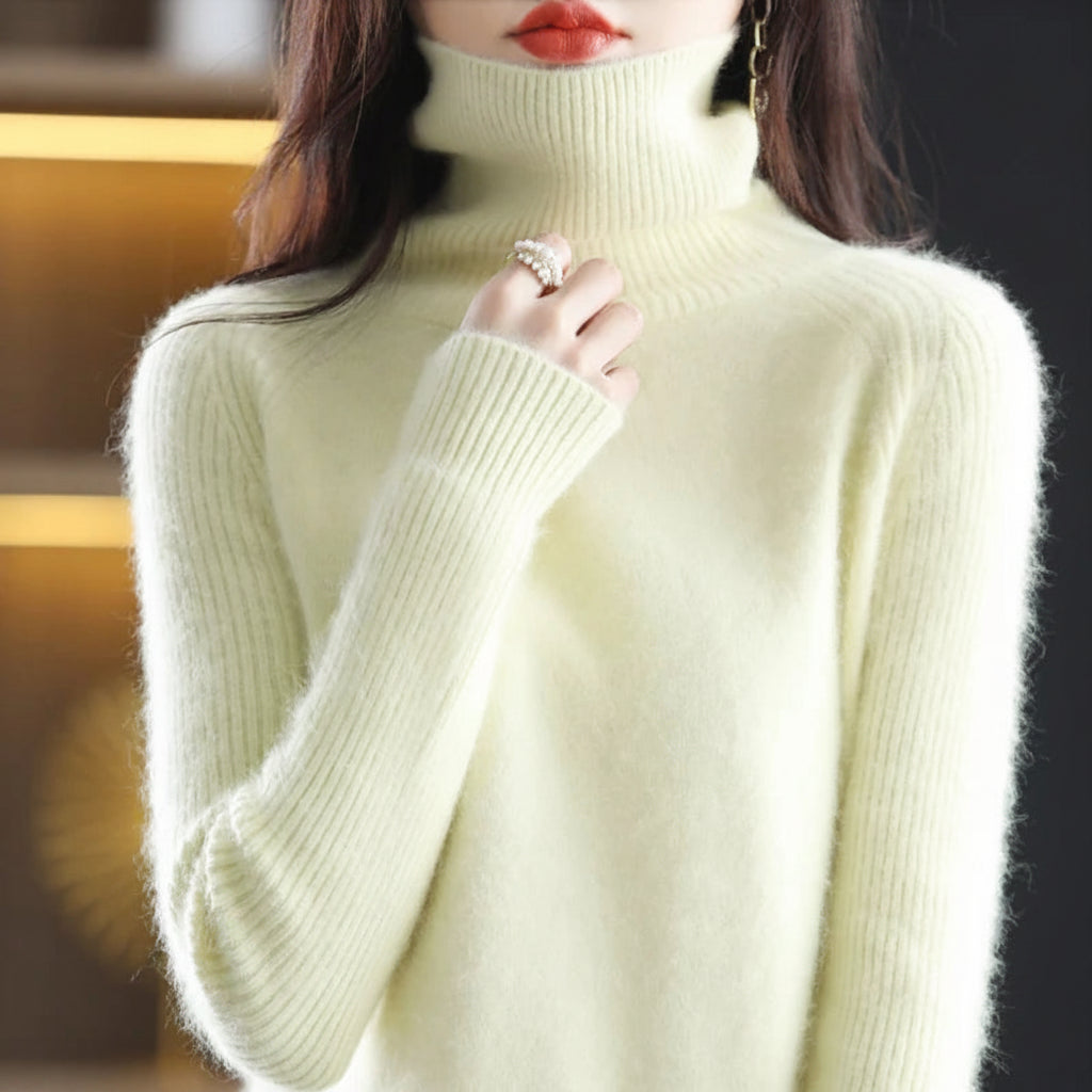 A woman wearing a soft, fuzzy high-neck turtleneck sweater in a pale buttery yellow color.