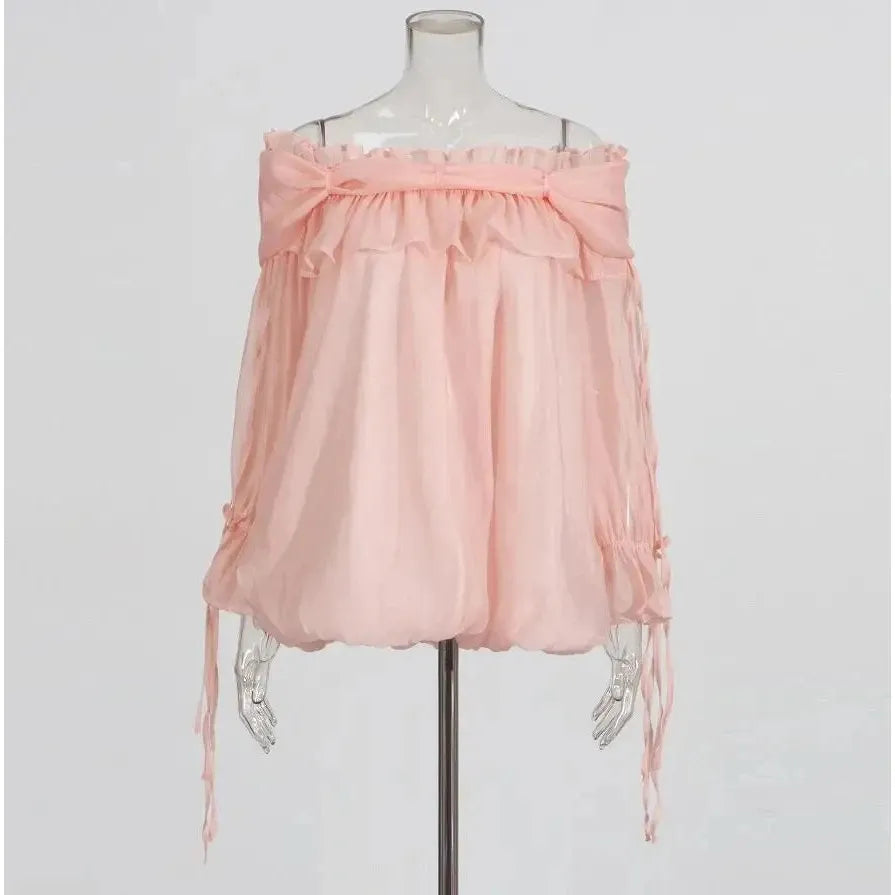 Pink off-shoulder top on a mannequin against a white background