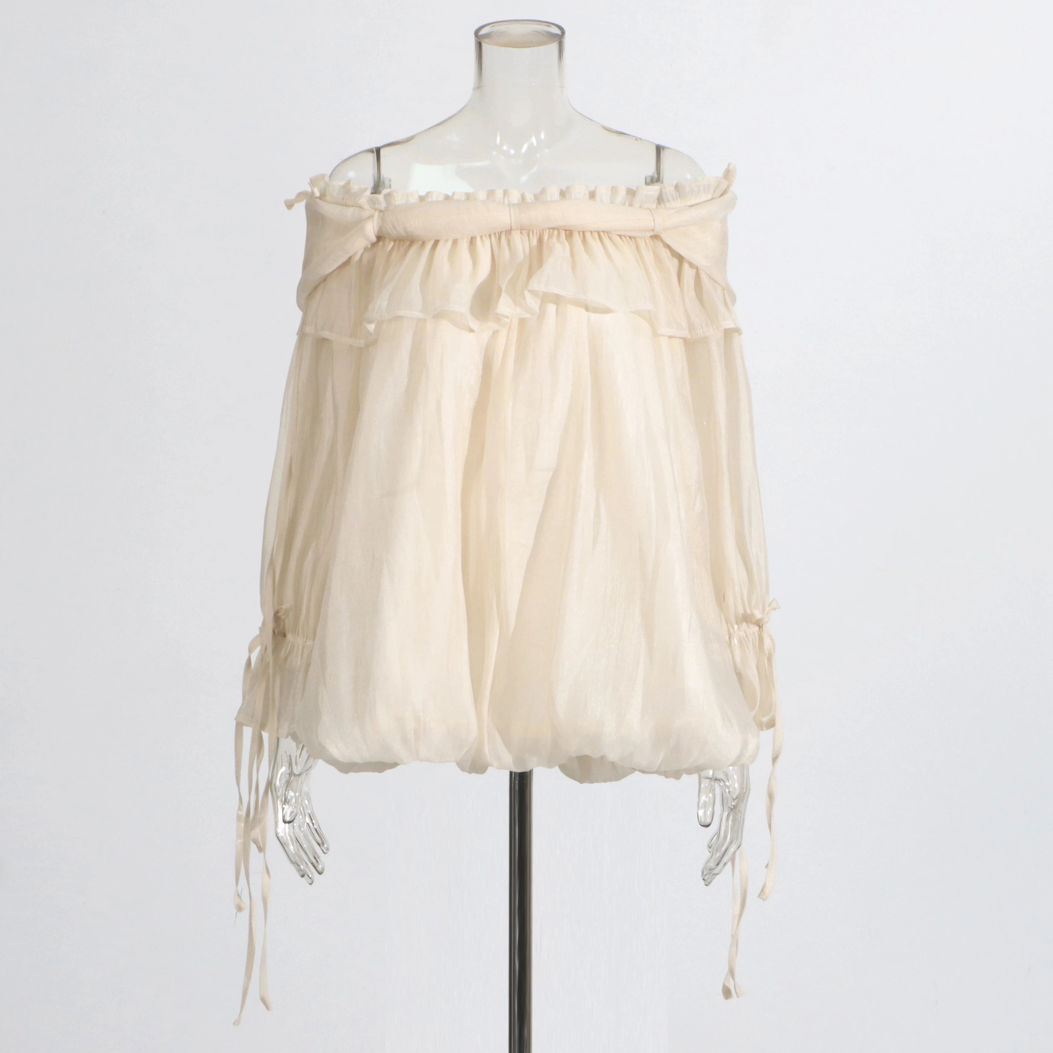 Beige off-shoulder top on a mannequin against a white background