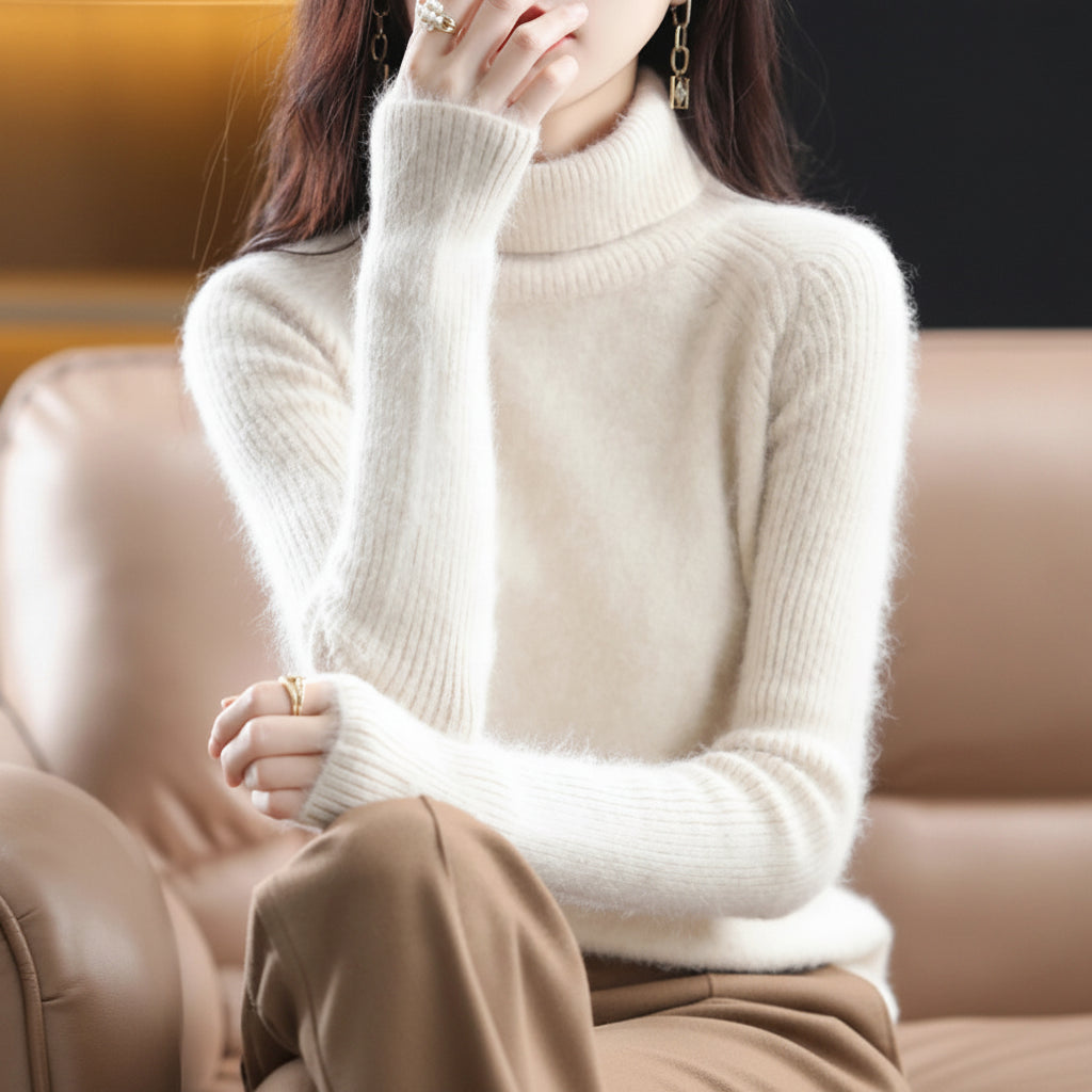A woman wearing a soft, fuzzy off-white/cream ribbed turtleneck sweater.