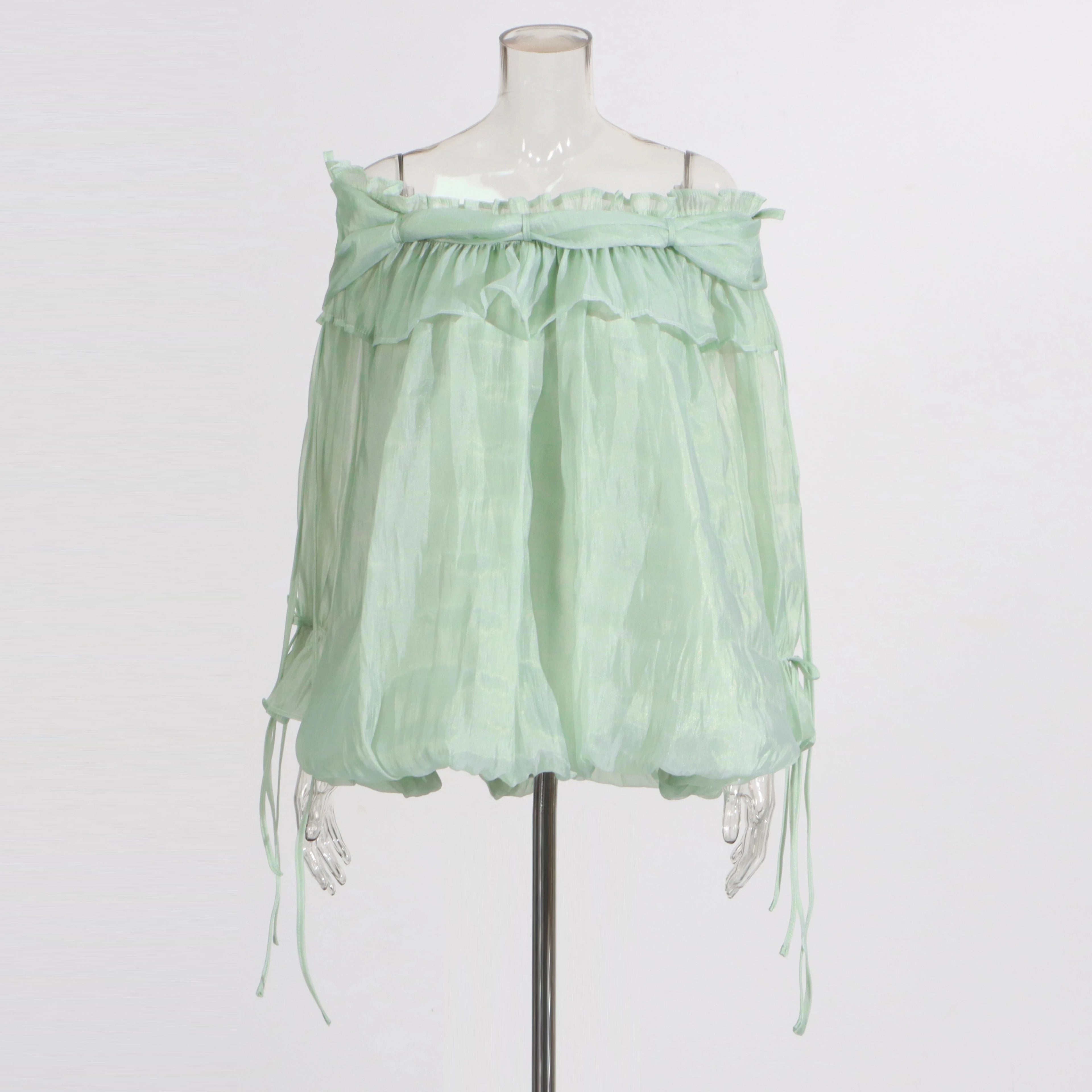 Light green off-shoulder top on a mannequin against a white background