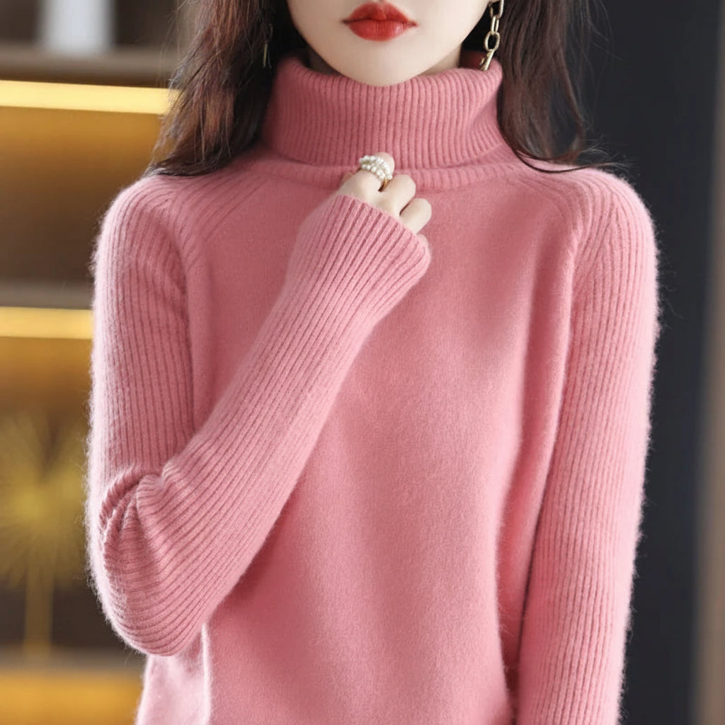 A woman wearing a pink ribbed turtleneck sweater.