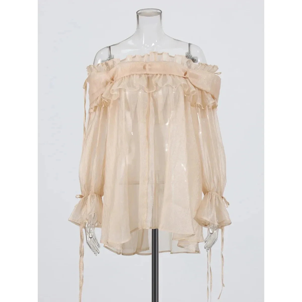 Beige off-shoulder blouse on a mannequin against a white background