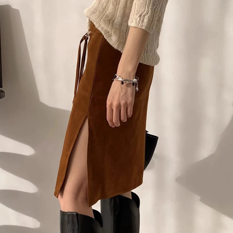 Brown skirt worn by a person against a neutral background